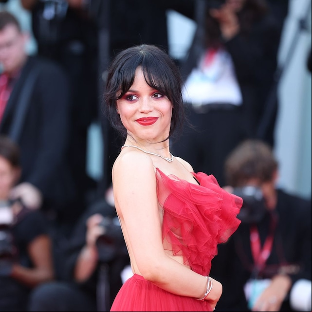 Plano medio de Jenna Ortega con conjunto rojo de tul con top y falda